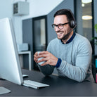 Aluratek AWHU02FB headset worn at a desk